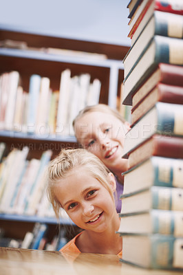 Buy stock photo Girls, books and playing in library for learning, education and fun with books, knowledge and portrait. Students, face and happy in school for development, study or history with academic scholarship 