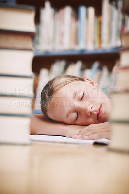 Buy stock photo A young girl fast asleep between two stacks of books in the library