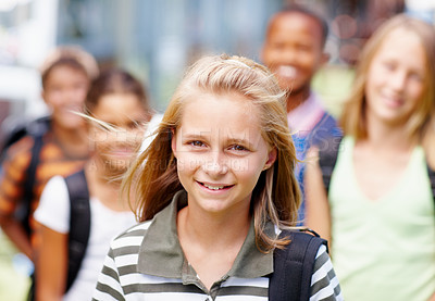 Buy stock photo Cute girl smiling at you with schoolmates standing in the background - copyspace