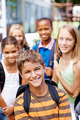 Buy stock photo Happy young schoolboy with his friends standing behind him - copyspace