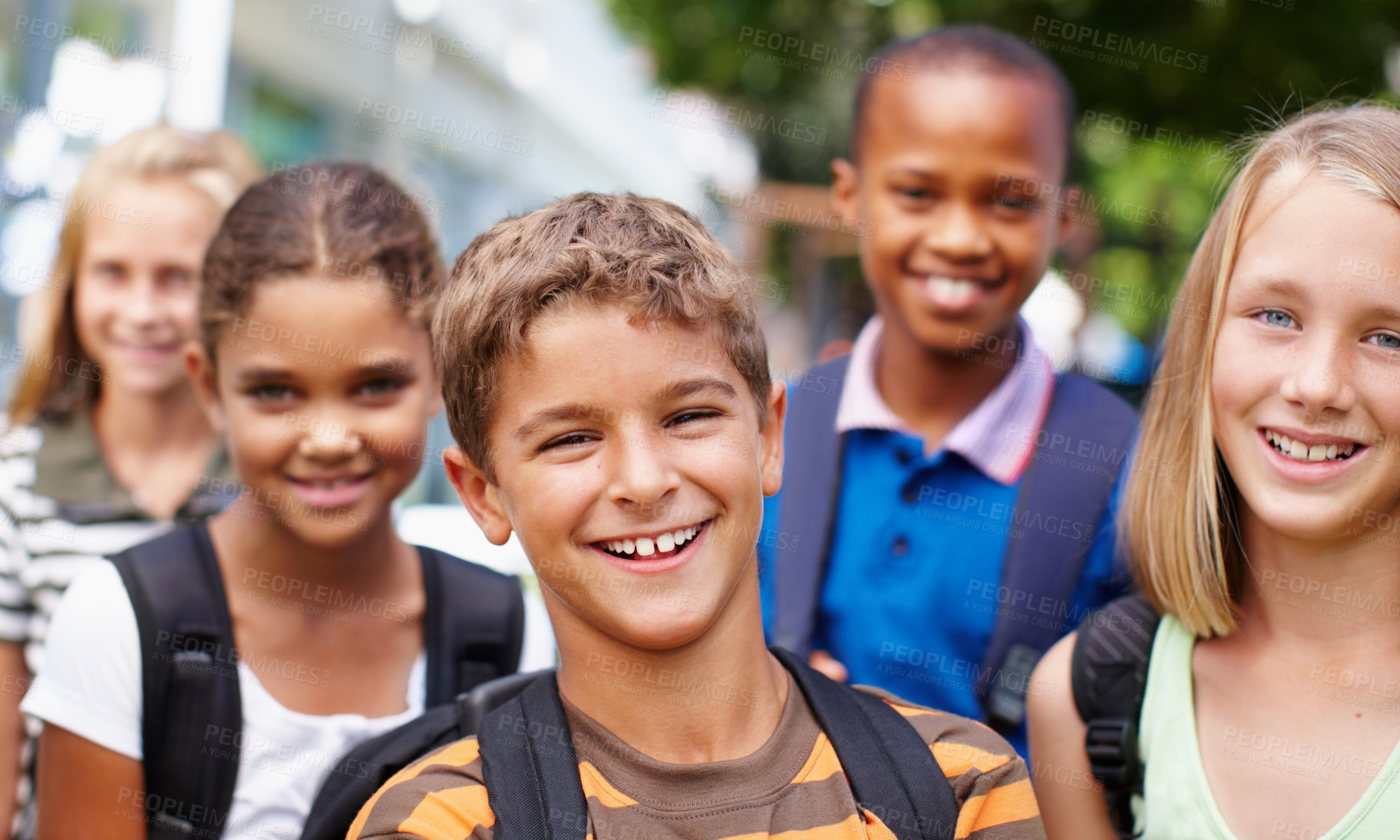 Buy stock photo Smiling group of children of different ethnic groups posing outside for a happy picture