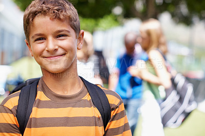 Buy stock photo Handsome little boy outside with schoolmates in the background - copyspace