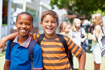 Buy stock photo Two boys who are best buddies posing for a picture in their playground - copyspace