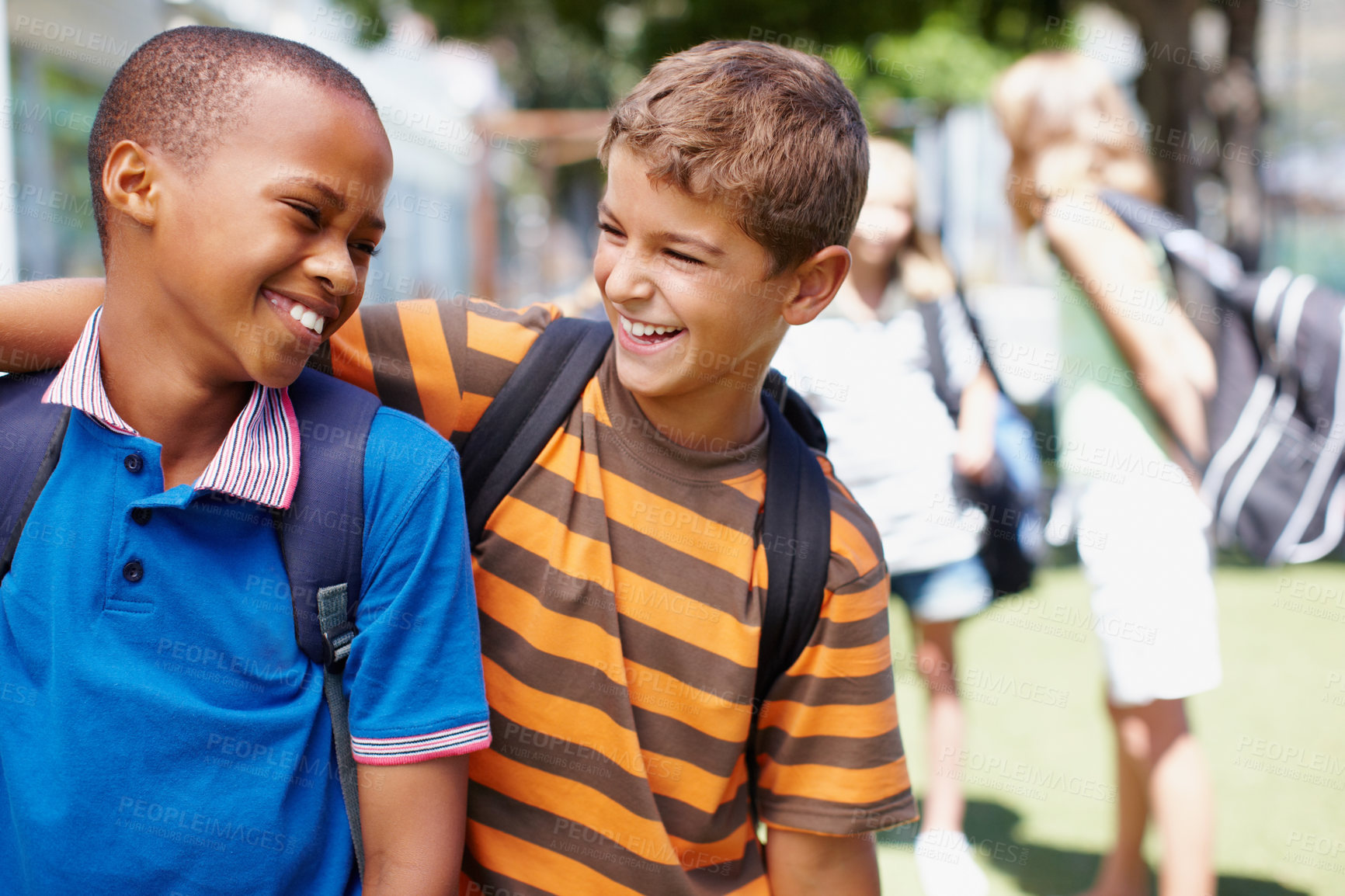 Buy stock photo Two boys in their school playground having a good laugh together - copyspace