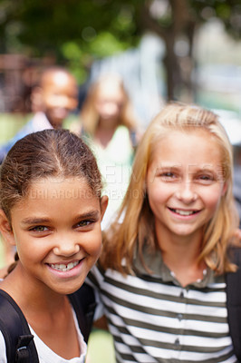 Buy stock photo Two school girls who are best friends smiling at the camera - copyspace