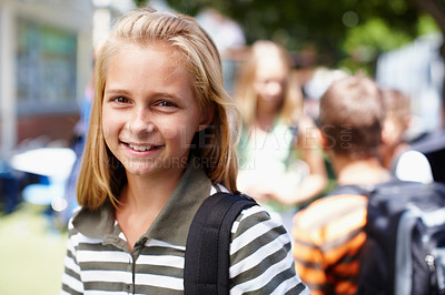 Buy stock photo Cute and confident school girl smiling at you with friends in the background - copyspace