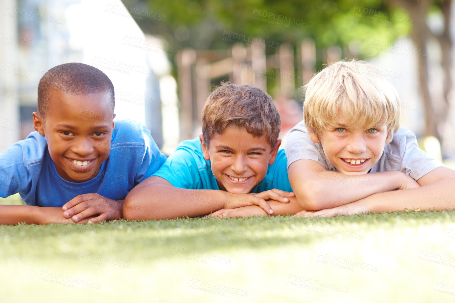 Buy stock photo Grass, friends and children in portrait for relax, connection and bonding together with happiness. Outdoor, diversity and boys with smile for childhood games, playful and reunion for school holiday