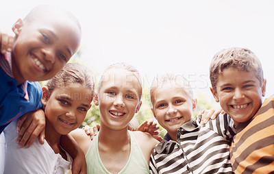 Buy stock photo A group of schoolkids hugging each other outdoors during recess