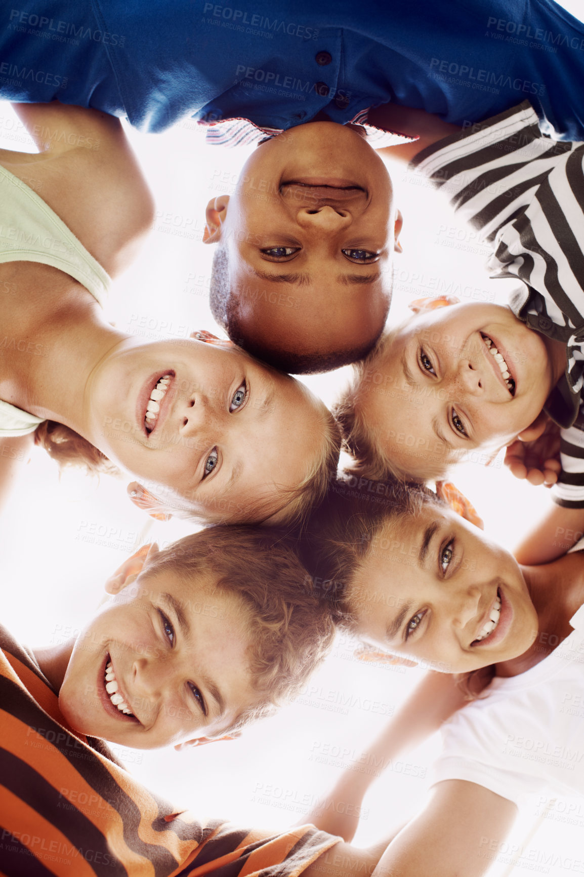 Buy stock photo Children, education and portrait of friends in huddle outdoor at school together for development. Diversity, smile or students with boy and girl kids in circle for learning or study from below.