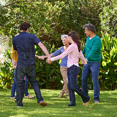 Buy stock photo Happy family, holding hands and dance together outdoor or play game in summer in a circle with grandparents. Ring a rosy, smile and children in garden on holiday, vacation and bonding with parents
