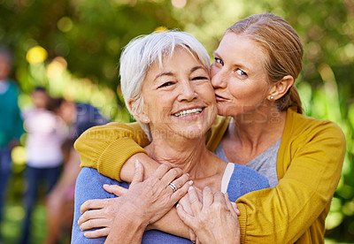 Buy stock photo Senior mother, woman and kiss in nature, outdoor and portrait with love, care and trees on holiday. Elderly mama, lady and embrace with bond, excited face and support in backyard with summer sunshine