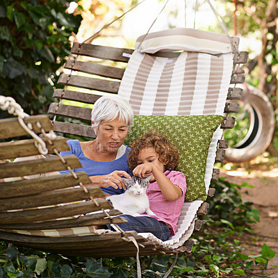 Buy stock photo Backyard, grandmother and boy with cat, relax and sunshine with weekend break and vacation. Family, old woman and grandchild with pet and hammock in a backyard with animal, bonding together in spring