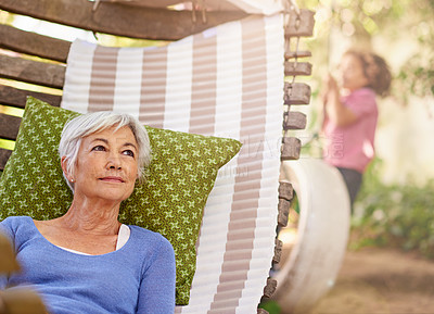 Buy stock photo Senior woman, think and garden with hammock to relax for retirement, break and enjoy. Bokeh, female person and
home with vision in summer or hot weather for outdoor and 
satisfied with me time.  