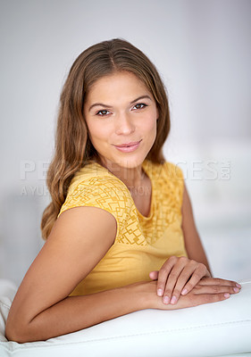 Buy stock photo Confident, portrait and woman on sofa to relax in house or home for comfort in living room for satisfaction. Face, peace and casual female person in apartment on resting break for wellness in Spain