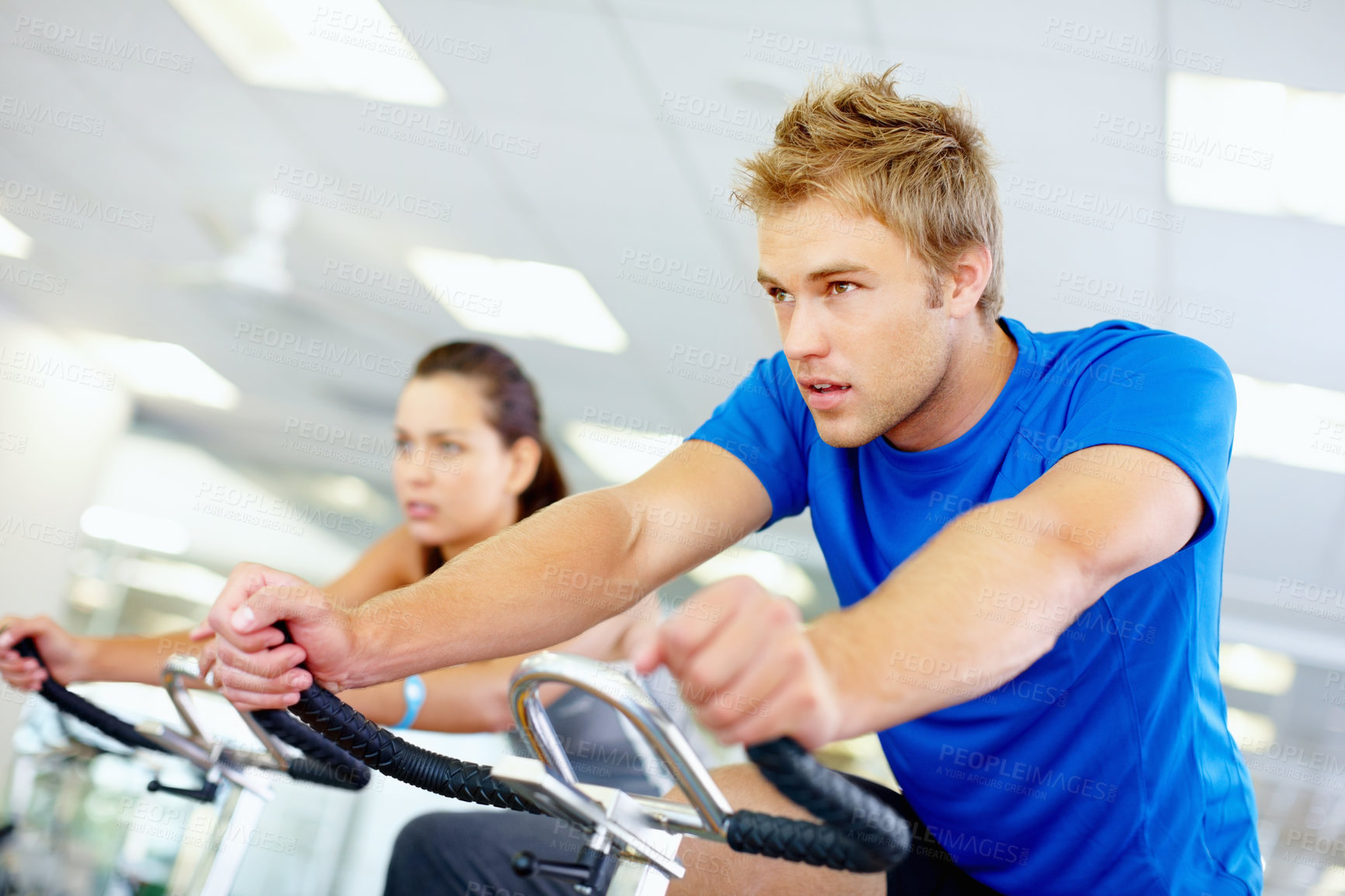 Buy stock photo Gym, spin class or man on bike machine in training and exercise for wellness, health or fitness. Athlete, active person or bicycle for cardio, strong power for workout, body or sports for cycling