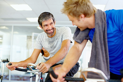 Buy stock photo Men talking while on stationary bike it the gym