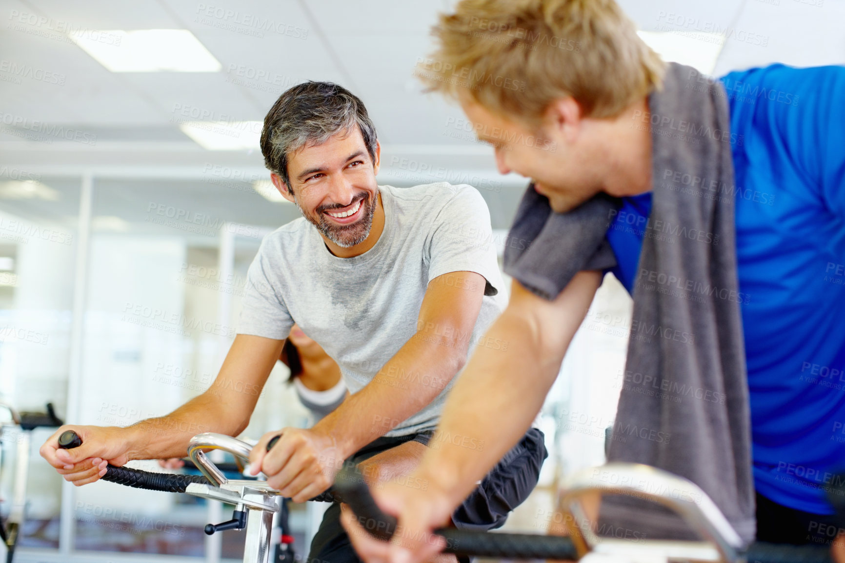 Buy stock photo Talking, spin class or happy people on cycling machine in training or exercise for wellness or fitness. Smile, healthy men or friends laughing on bicycle for cardio, power for workout, body or sports