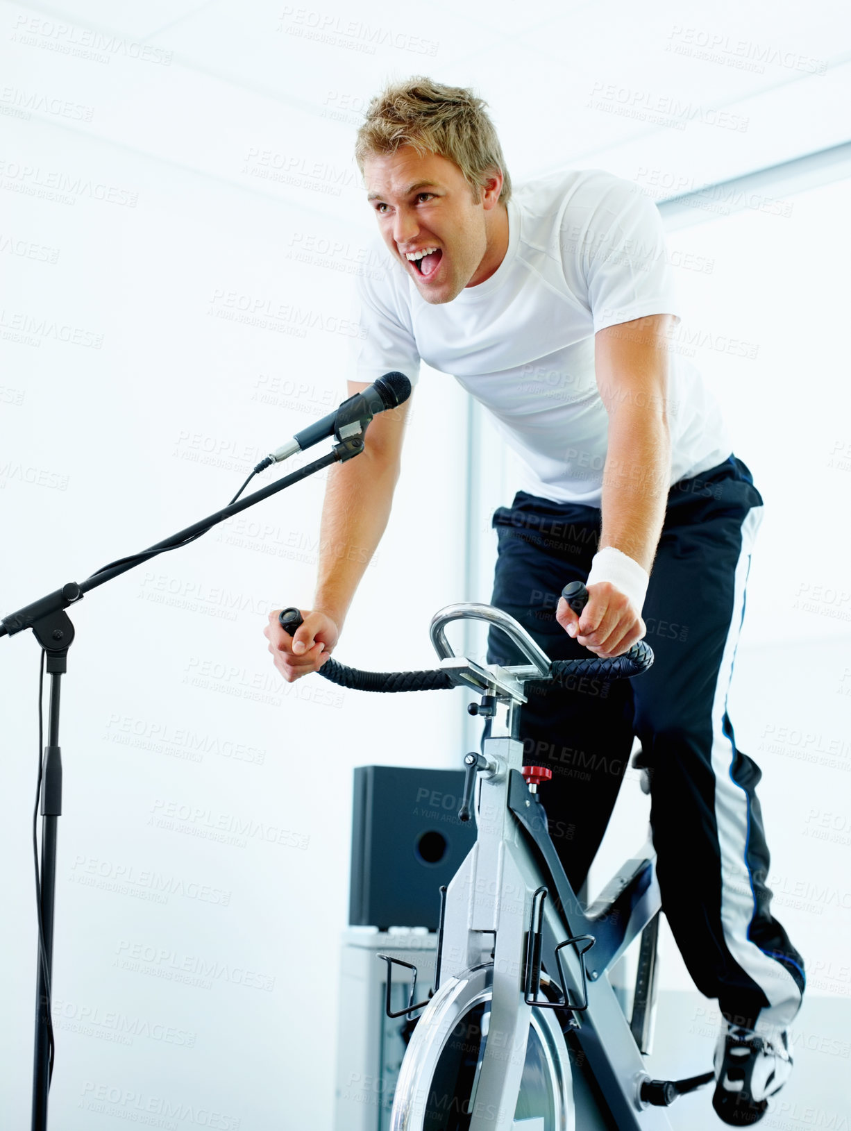 Buy stock photo Man, workout and cycling class at the gym for exercise, fitness or healthy cardio training.Singing, shout and microphone with stationary bicycle or spin bike for health, wellness or endurance