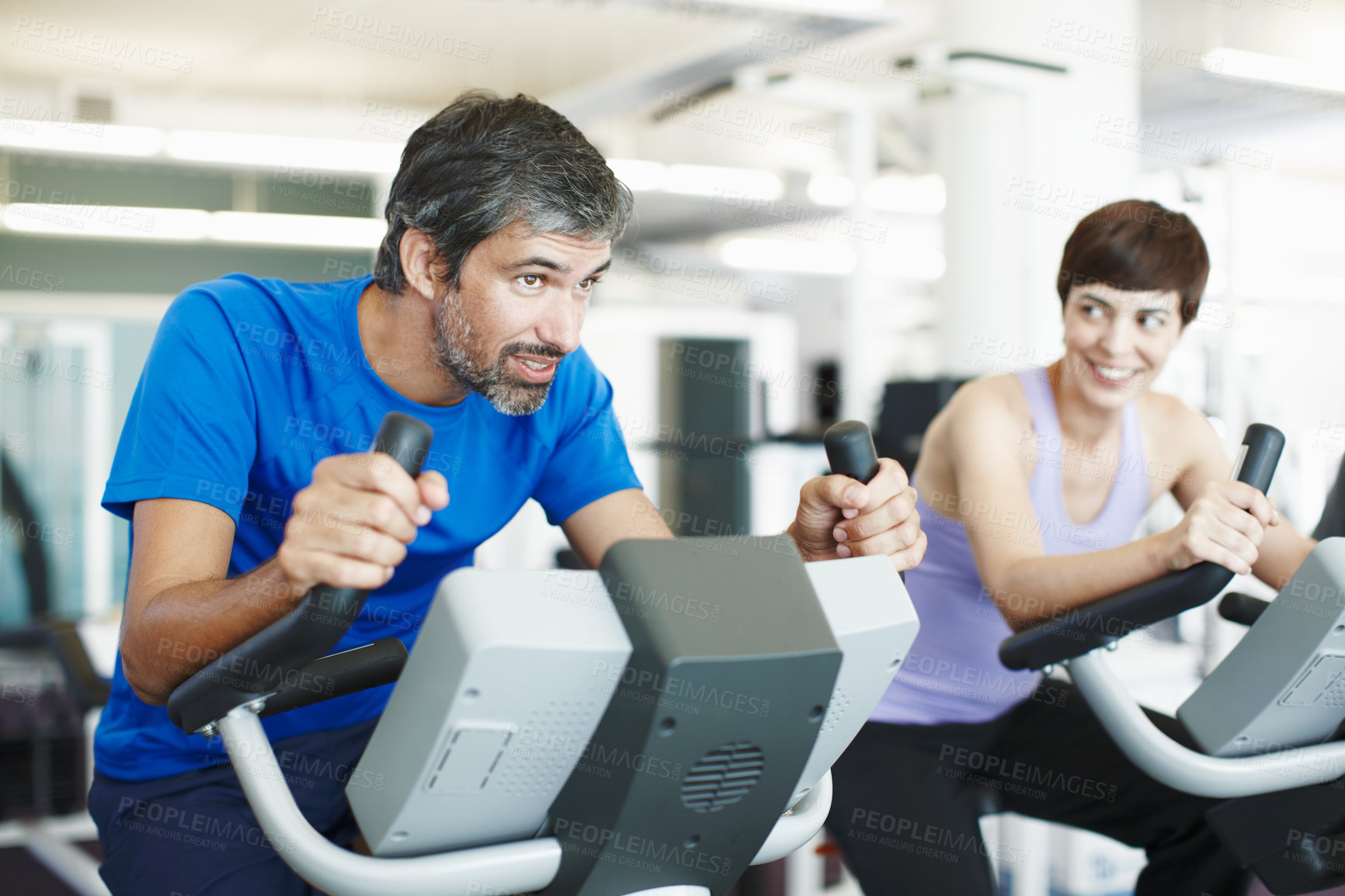 Buy stock photo Happy, spin class or couple on bike machine in training or exercise for wellness, gym or fitness. Active, healthy or people cycling on bicycle for cardio, power or intense body workout to lose weight