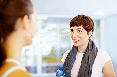 Buy stock photo Beautiful fitness woman having a friendly chat with friend after workout