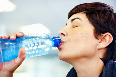 Buy stock photo Closeup of beautiful woman drinking water after workout at gym