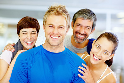Buy stock photo Portrait of handsome young man with his friends at fitness center