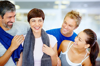 Buy stock photo Portrait of beautiful woman holding towel with her friends at fitness center