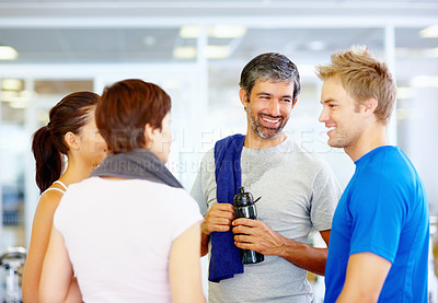 Buy stock photo Mature man conversing with friends after workout at gym