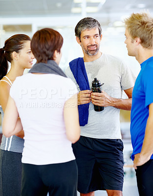 Buy stock photo Portrait of mature man talking with friends at fitness center