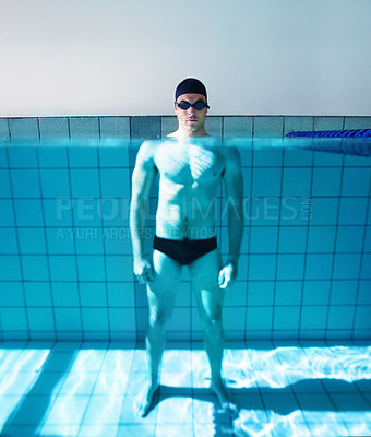 Buy stock photo Portrait of a young male swimmer standing in a swimming pool