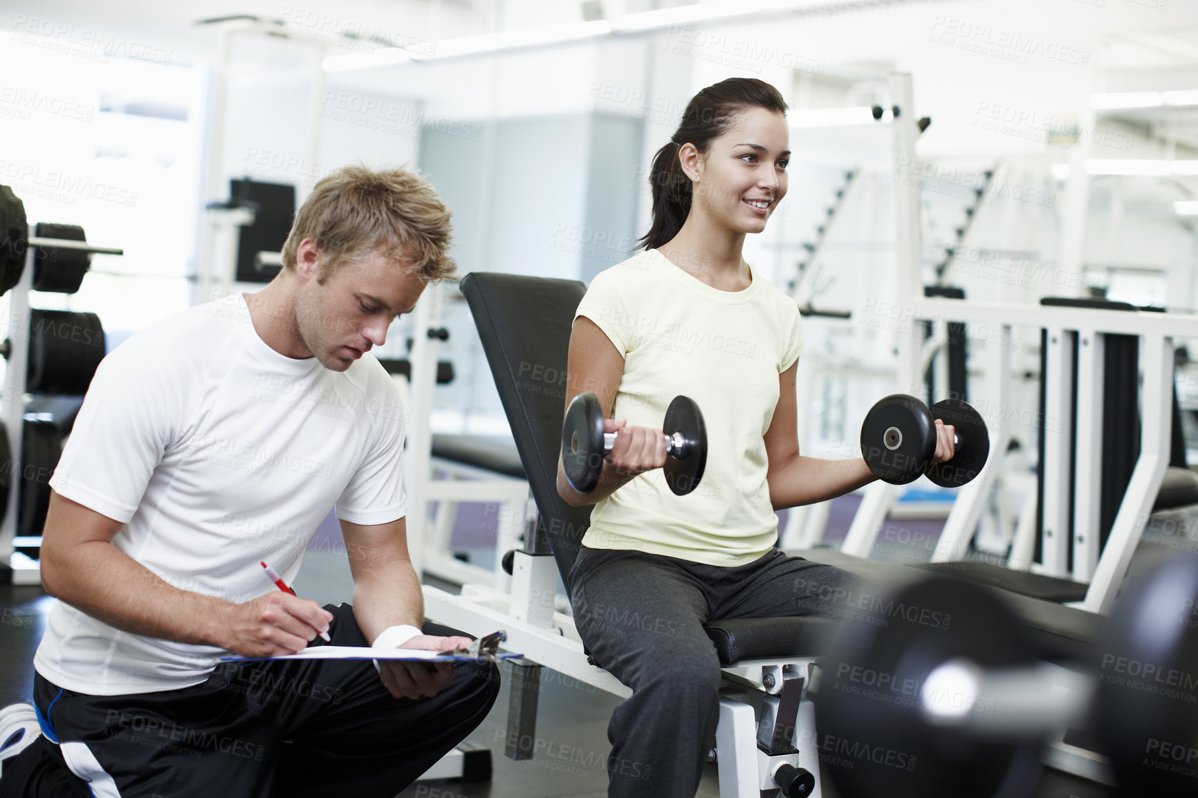 Buy stock photo Personal trainer, clipboard and people with exercise in gym for weightlifting, coaching and notes. Woman, fitness and man with checklist in session for training, help and tracking progress in workout