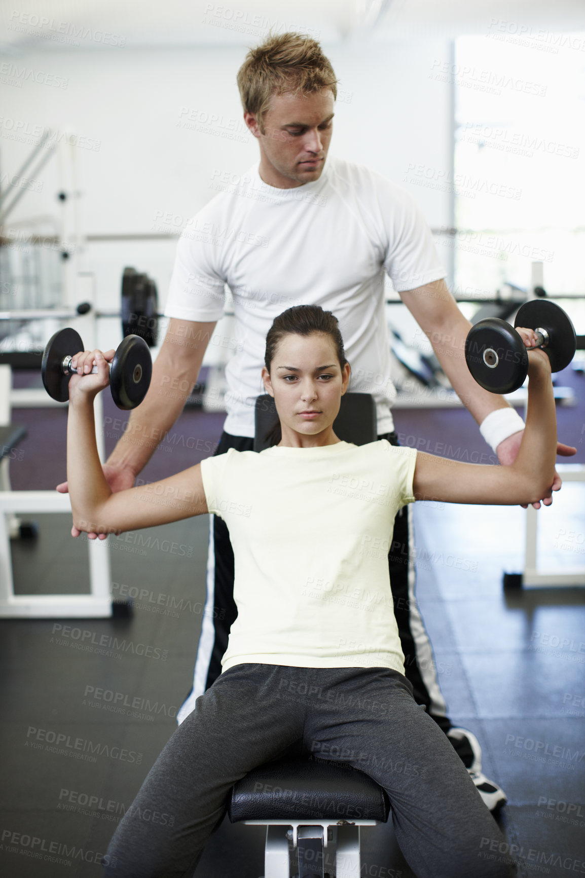 Buy stock photo Personal trainer, dumbbells and people with exercise in gym for weightlifting, coaching and spotting. Woman, fitness and man holding arms in session for training, help and workout for healthy body