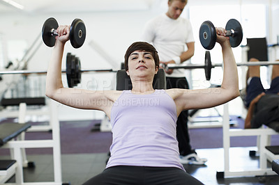 Buy stock photo Woman, dumbbells and exercise in portrait on bench for training, wellness or muscle development at gym. Person, weightlifting and workout for bodybuilding, fitness or power with strong arms in Greece