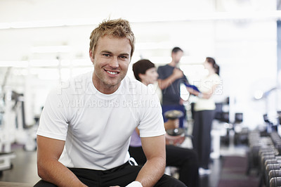 Buy stock photo Cropped shot of a handsome young man sitting in the gym