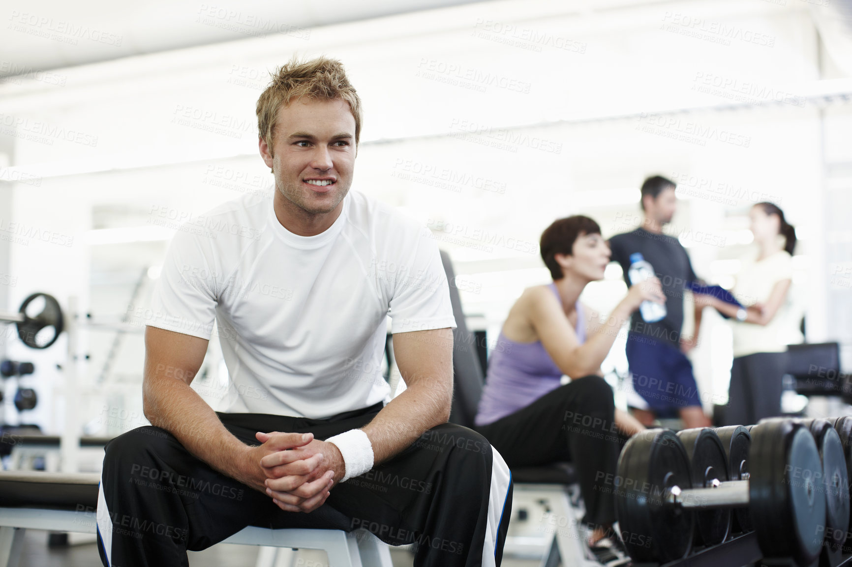 Buy stock photo Cropped shot of a handsome young man sitting in the gym