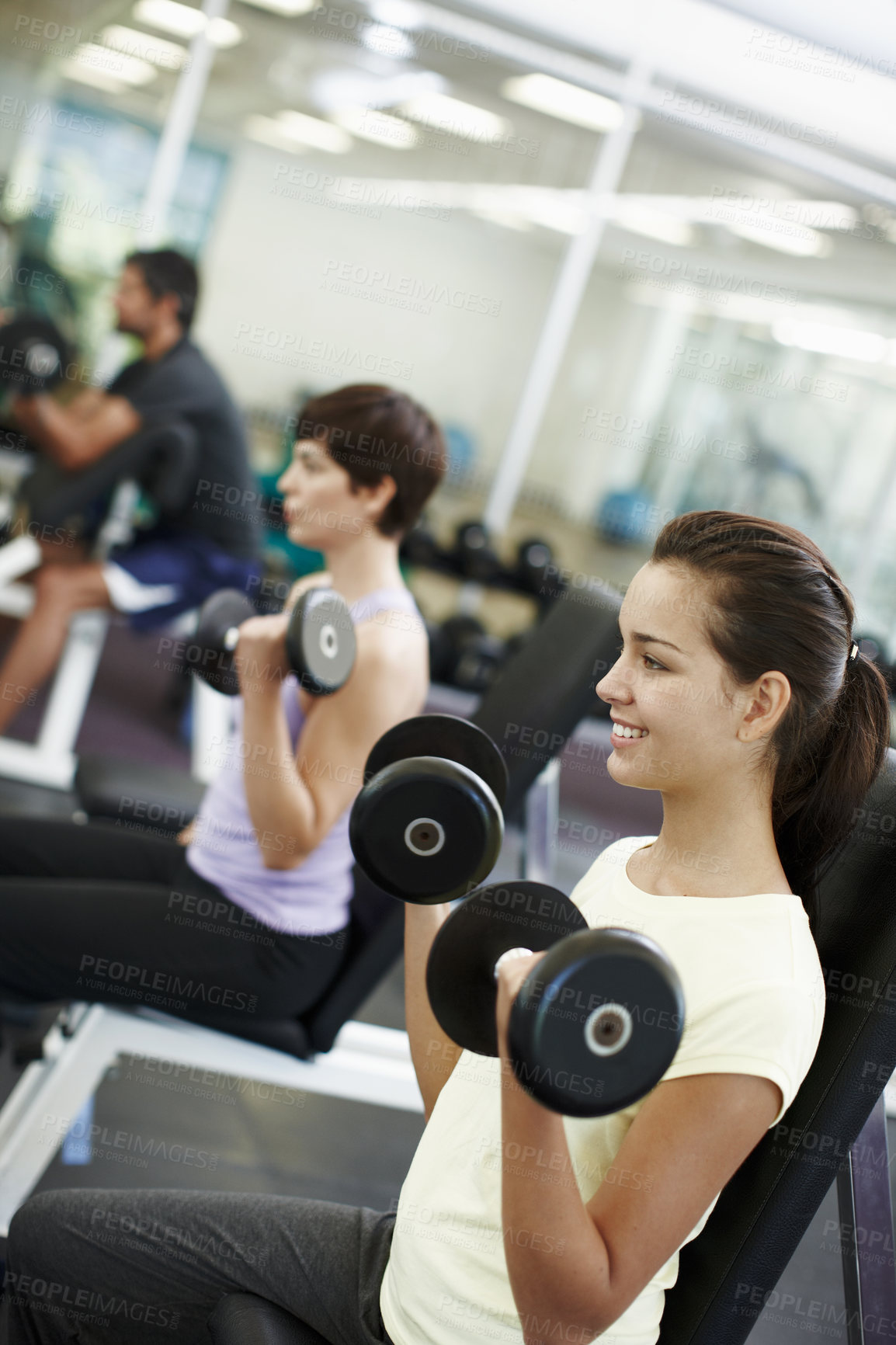 Buy stock photo Cropped shot of people working out with dumbbells in the gym