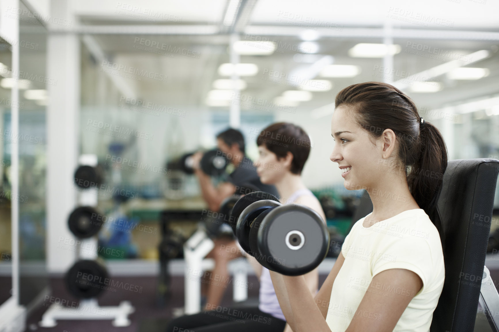 Buy stock photo Cropped shot of people working out with dumbbells in the gym