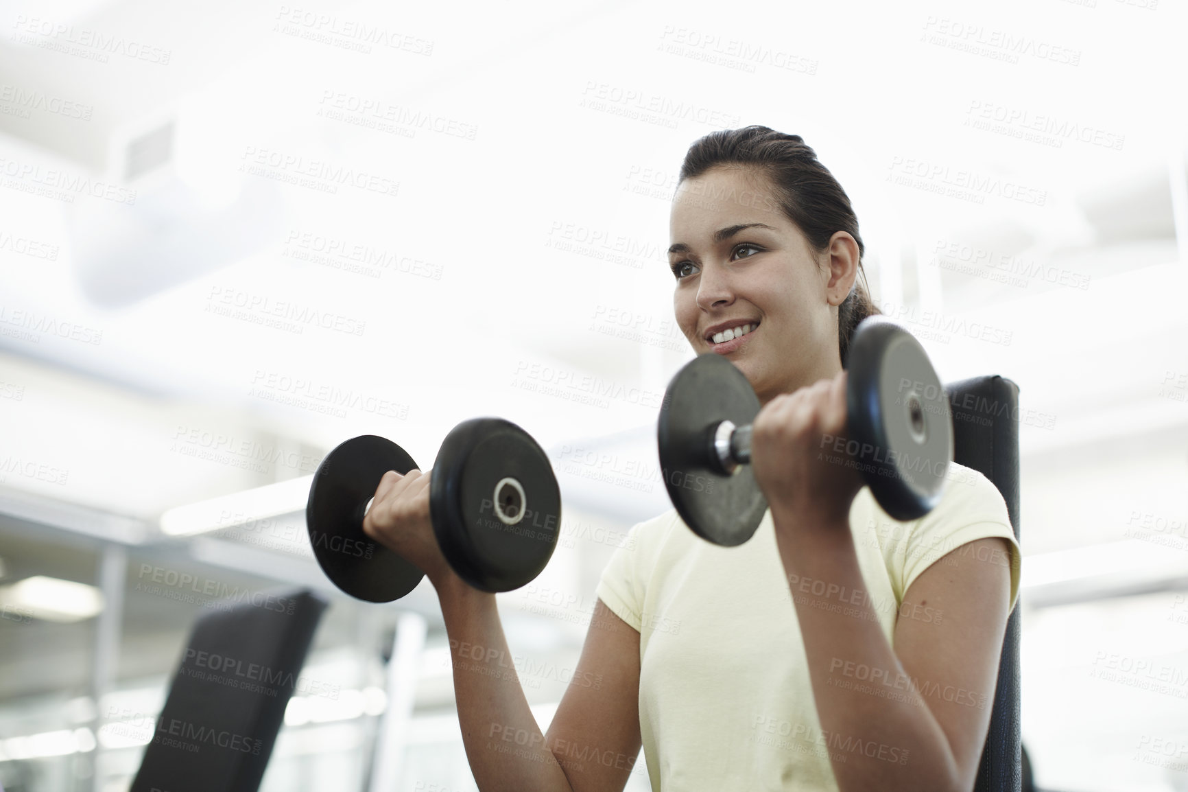 Buy stock photo Fitness, smile and woman with weights in gym for bodybuilding, exercise and wellness in morning. Happy, athlete and female person with equipment in health club for strength, training and workout