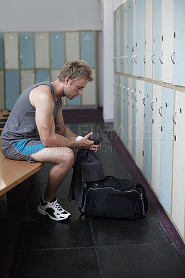 Buy stock photo Crppped shot of a young man in the gym after a solid workout