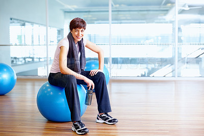 Buy stock photo Portrait of beautiful fit woman sitting on exercise ball and smiling