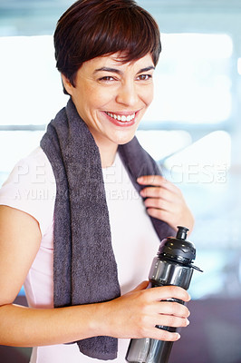 Buy stock photo Happy woman with towel and water bottle relaxing during a break from training session