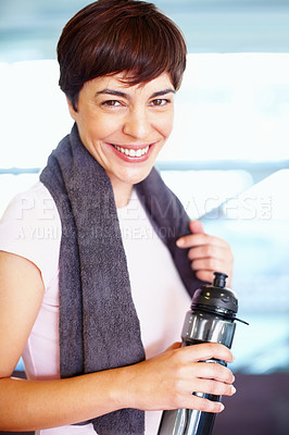 Buy stock photo Portrait of woman with towel and water bottle smiling during workout