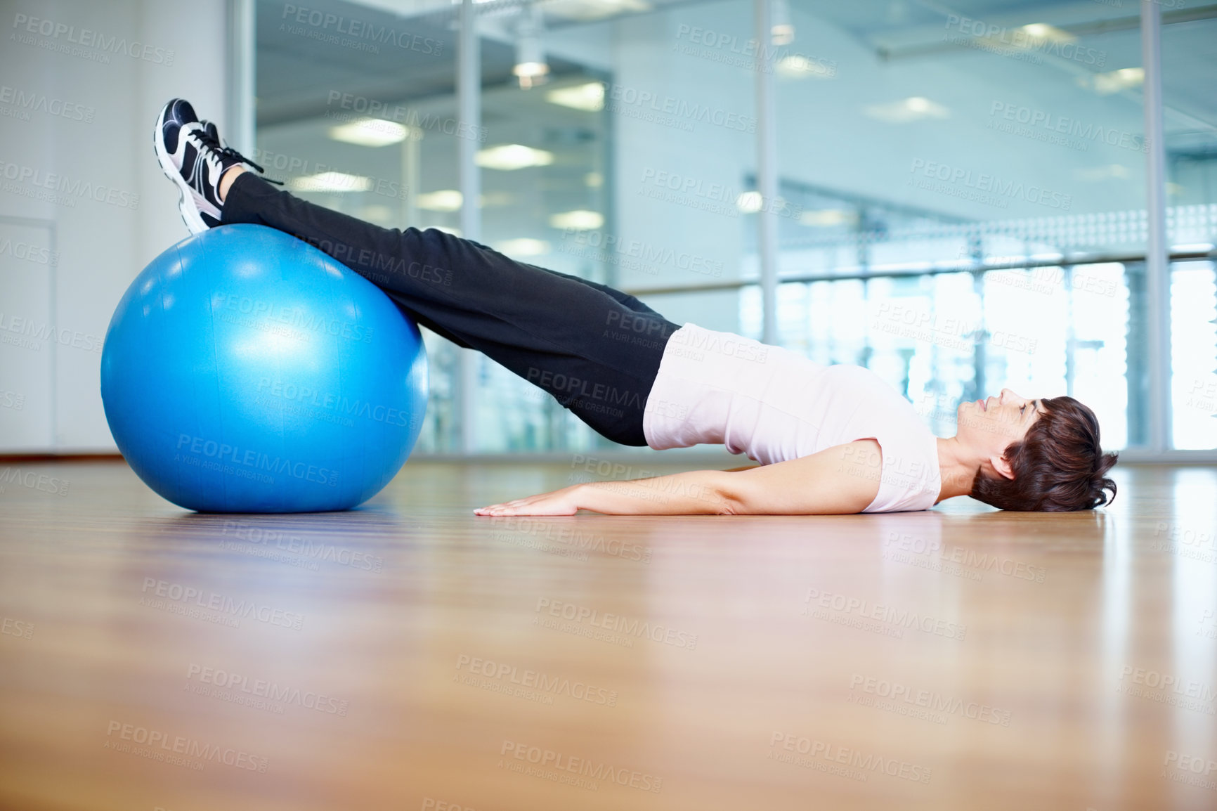 Buy stock photo Full length of woman using exercise ball during a workout session