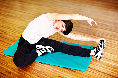 Buy stock photo Portrait of smiling woman doing a stretching exercise in gym