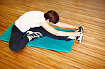 Woman stretching on exercise mat