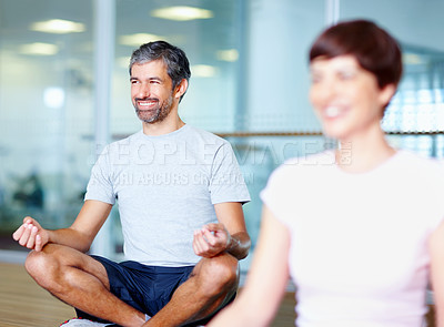 Buy stock photo Smiling mature man in lotus position with woman in foreground