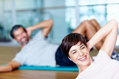 Buy stock photo Attractive woman in stretching pose with man in background