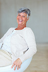 Smiling mature woman on chair