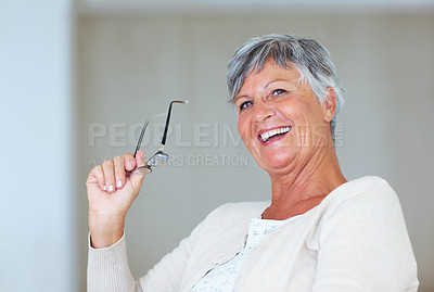 Buy stock photo Cheerful mature woman smiling while holding specs