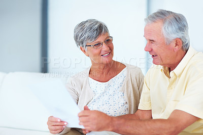 Buy stock photo Happy mature woman and man discussing domestic bills at home